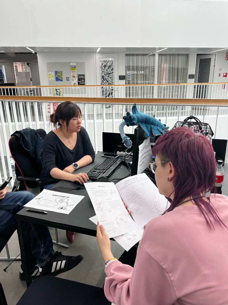 Playtest session reviewing XenoEtiquette materials in the media lab